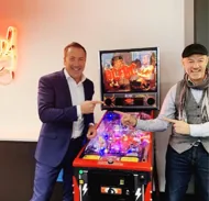 RUBIX team members at a pinball machine during a client event