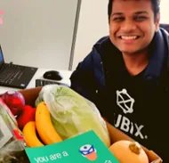 A RUBIX team member with a care package delivered to their home